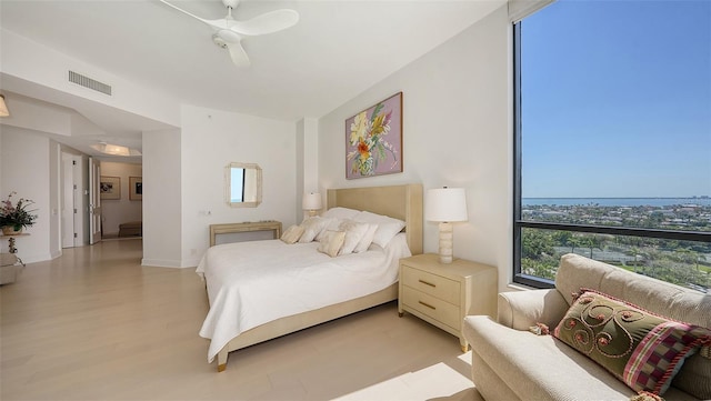 1241 Gulf Of Mexico Dr Unit 803, Longboat Key, FL 34228 - bedroom with light wood-style flooring and ceiling fan