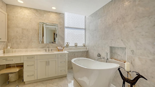 1241 Gulf Of Mexico Dr Unit 803, Longboat Key, FL 34228 - full bathroom with tile walls, a freestanding tub, and vanity
