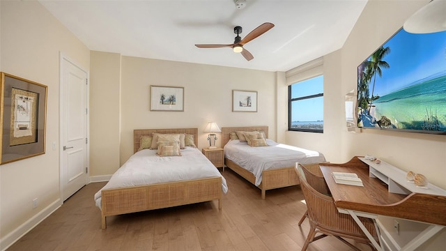 1241 Gulf Of Mexico Dr Unit 803, Longboat Key, FL 34228 - bedroom with wood finished floors, a ceiling fan, and baseboards