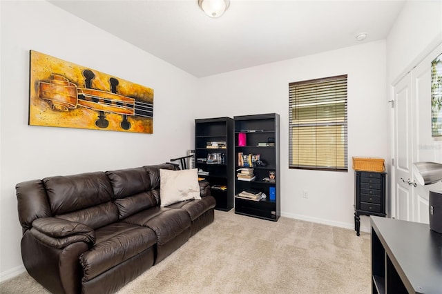 living area featuring light carpet and baseboards