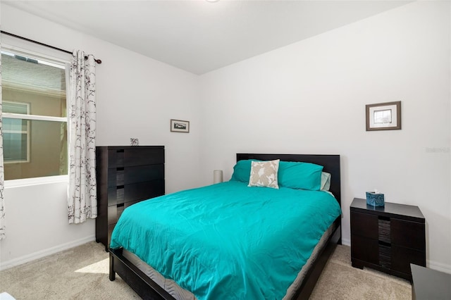 bedroom with carpet floors and baseboards