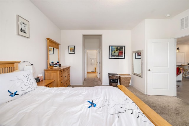 bedroom with light colored carpet and baseboards