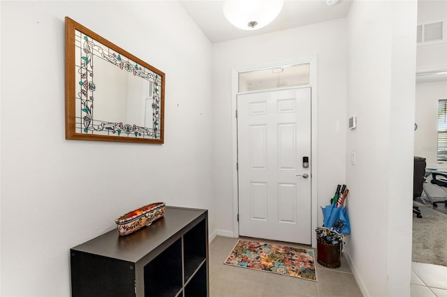 tiled entrance foyer featuring baseboards