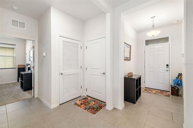 entrance foyer featuring baseboards and light tile patterned floors