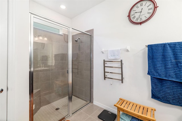 full bathroom featuring a stall shower, tile patterned floors, and baseboards