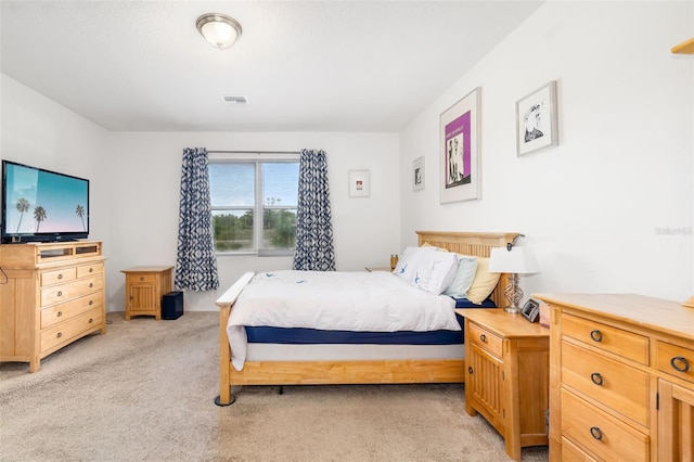 bedroom featuring light colored carpet