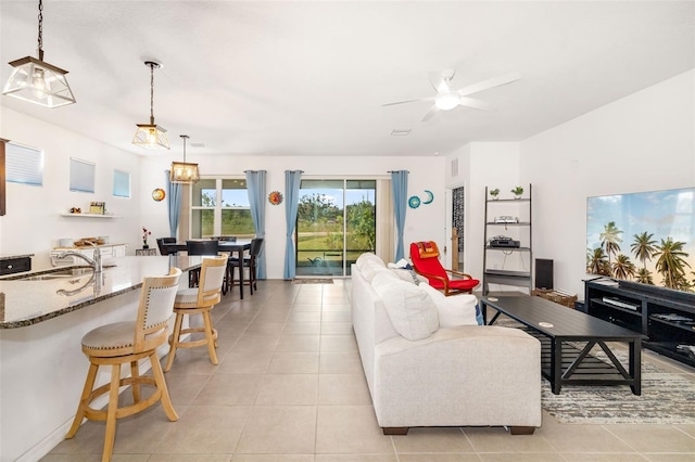 living room featuring ceiling fan and light tile patterned flooring