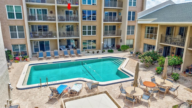 community pool with a patio area