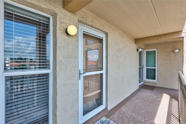 view of exterior entry featuring stucco siding