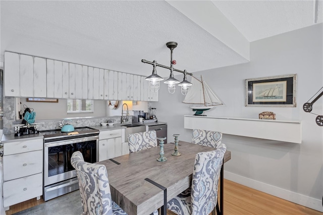 dining area with baseboards and light wood-type flooring