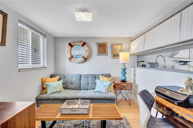 living area with light wood finished floors and baseboards