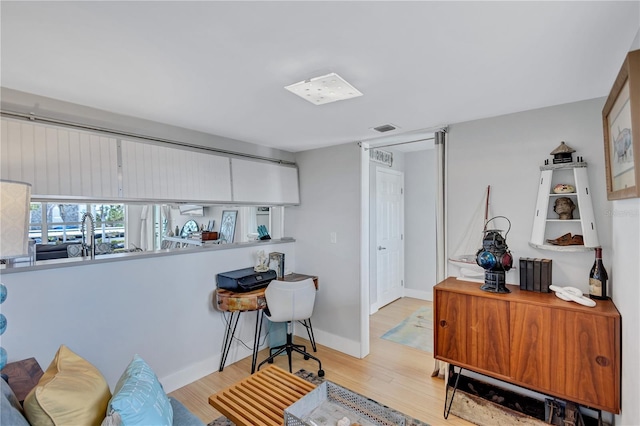 home office featuring wood finished floors and baseboards