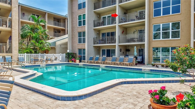 community pool featuring fence and a patio