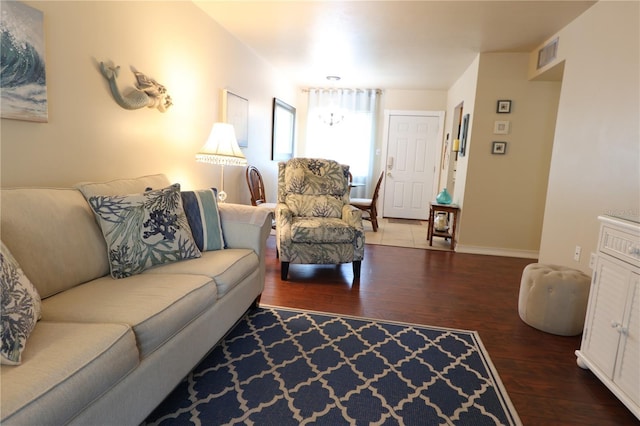 living room with baseboards, hardwood / wood-style floors, and visible vents