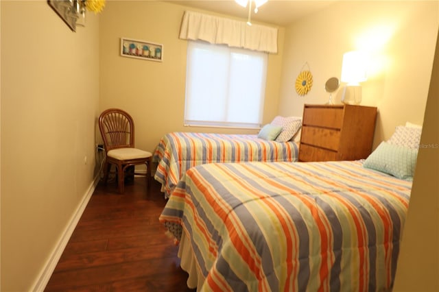 bedroom with baseboards and hardwood / wood-style floors