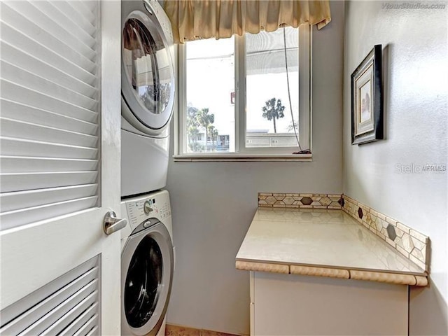 laundry room featuring stacked washing maching and dryer and laundry area