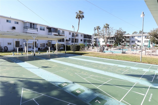 surrounding community with shuffleboard and a residential view