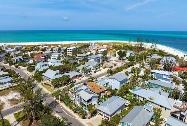 aerial view of residential area featuring extended coastline