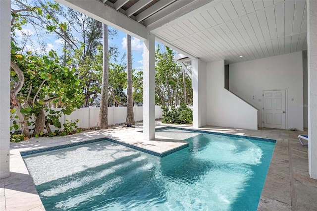 view of swimming pool with fence and a patio