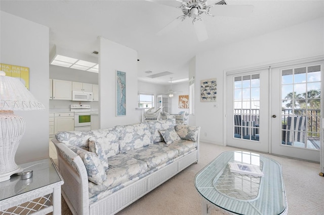 living room featuring ceiling fan, light carpet, and french doors
