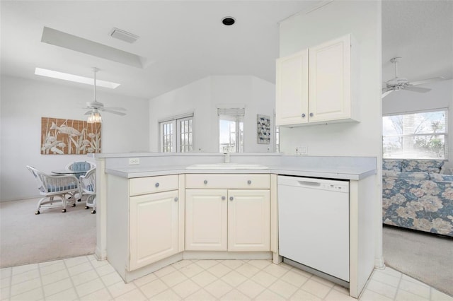 kitchen with dishwasher, light carpet, ceiling fan, and light countertops