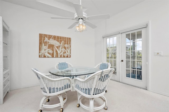 dining room featuring carpet floors, ceiling fan, and french doors