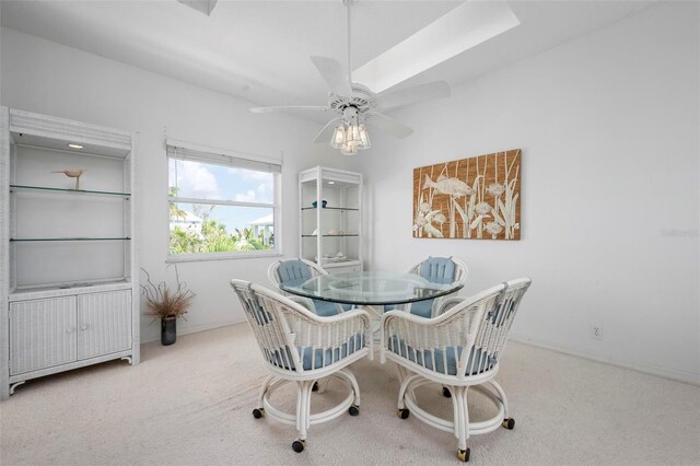 carpeted dining space featuring a ceiling fan