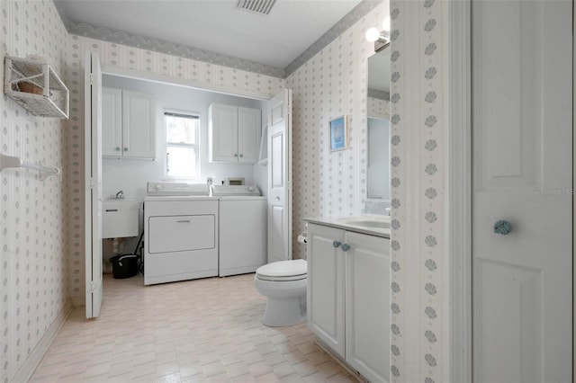 full bath with wallpapered walls, washer and clothes dryer, vanity, and toilet