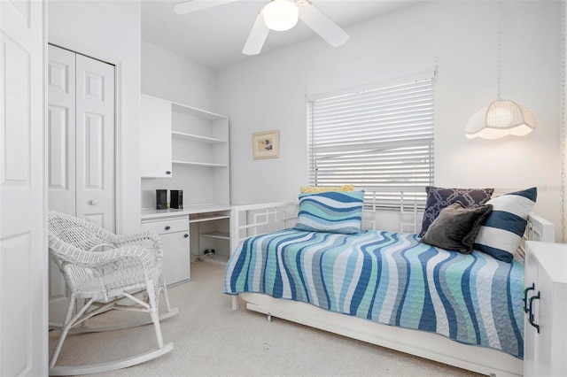 bedroom featuring light carpet, a closet, and ceiling fan