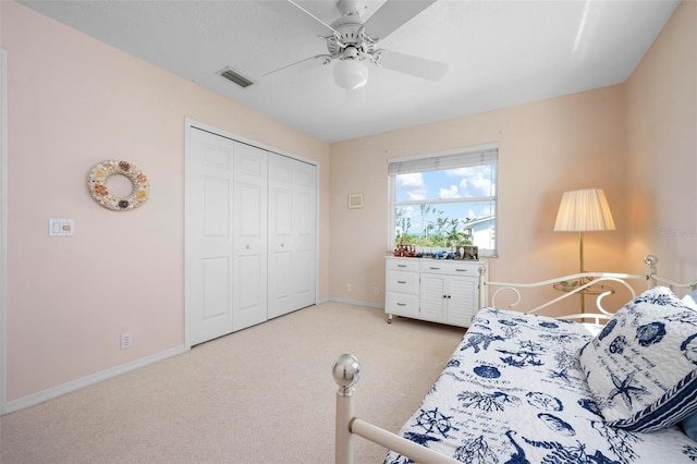carpeted bedroom featuring a closet, baseboards, and a ceiling fan