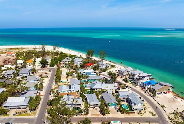 aerial view of residential area with expansive beach