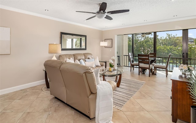 living room featuring light tile patterned flooring, a textured ceiling, crown molding, a ceiling fan, and baseboards