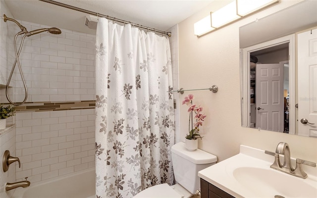 bathroom with toilet, vanity, and shower / bath combo