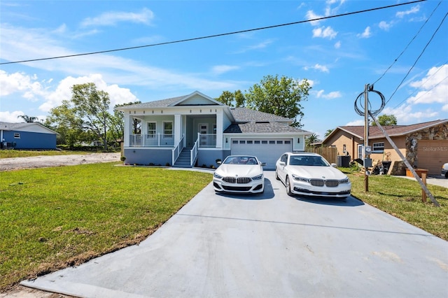 8622 Inwood Dr, Hudson, FL 34667 - view of front of property featuring a garage, a front lawn, central AC unit, a porch, and driveway
