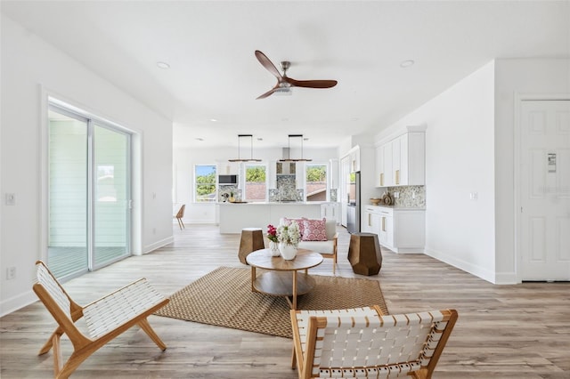 8622 Inwood Dr, Hudson, FL 34667 - living room with light wood finished floors, baseboards, ceiling fan, and recessed lighting