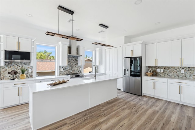 8622 Inwood Dr, Hudson, FL 34667 - kitchen with backsplash, light countertops, stainless steel appliances, and a sink