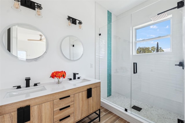 8622 Inwood Dr, Hudson, FL 34667 - full bathroom with double vanity, wood finished floors, a shower stall, and a sink