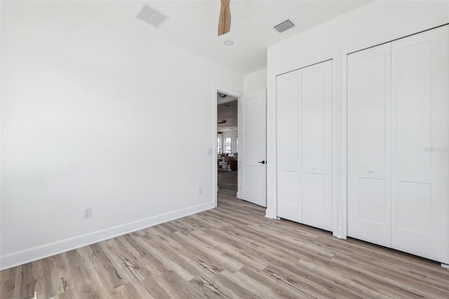 8622 Inwood Dr, Hudson, FL 34667 - unfurnished bedroom with multiple closets, baseboards, visible vents, and light wood-style floors