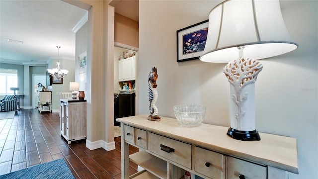 1503 Calle Grand St, Bradenton, FL 34209 - hall with crown molding, a chandelier, baseboards, and wood finish floors