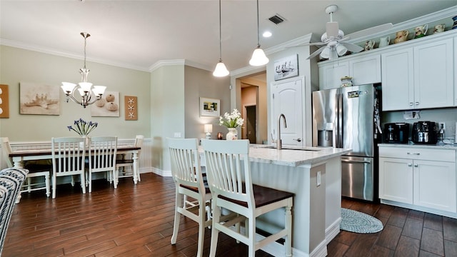 1503 Calle Grand St, Bradenton, FL 34209 - kitchen with stainless steel refrigerator with ice dispenser, dark wood-style flooring, a sink, ornamental molding, and light stone countertops