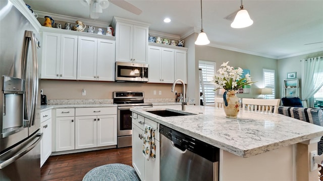 1503 Calle Grand St, Bradenton, FL 34209 - kitchen featuring stainless steel appliances, a sink, dark wood-style floors, hanging light fixtures, and light stone countertops