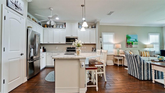 1503 Calle Grand St, Bradenton, FL 34209 - kitchen with stainless steel appliances, crown molding, open floor plan, dark wood-style flooring, and ceiling fan