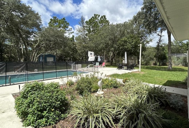 view of pool featuring a yard, fence, a fenced in pool, and a patio area