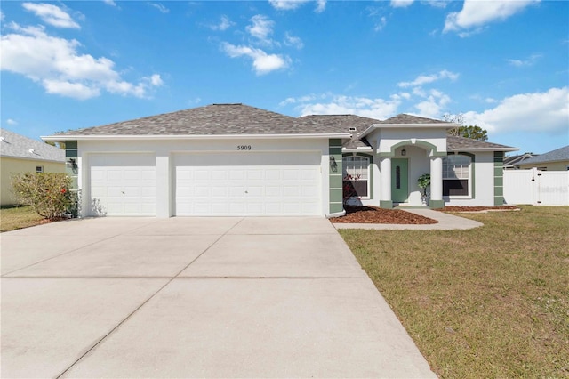view of front of house with an attached garage, concrete driveway, and stucco siding