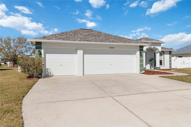 ranch-style house featuring concrete driveway, stucco siding, and an attached garage