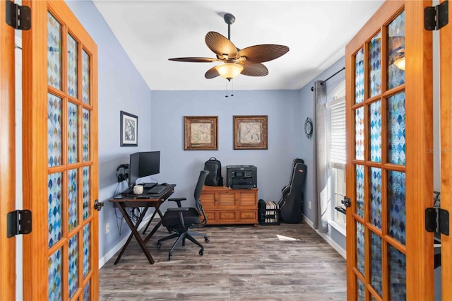 office space with wood finished floors, ceiling fan, and baseboards