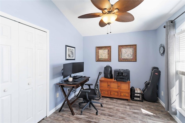 office area featuring lofted ceiling, ceiling fan, wood finished floors, and baseboards
