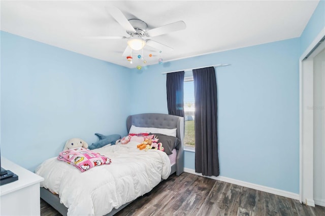 bedroom with baseboards, wood finished floors, and ceiling fan