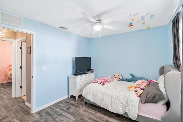 bedroom featuring wood finished floors, baseboards, and ceiling fan
