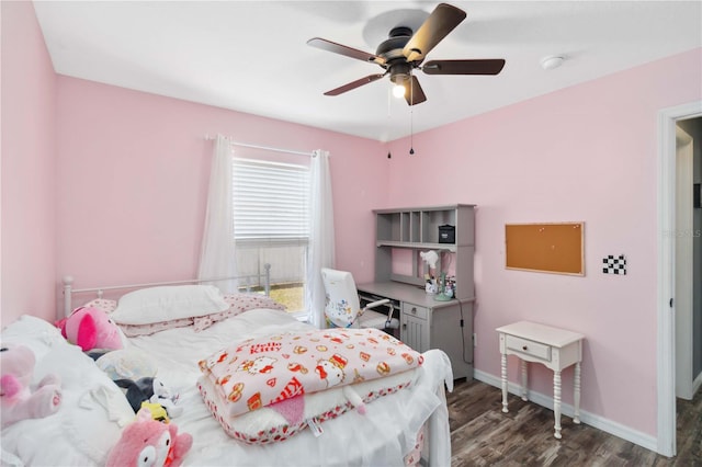 bedroom with wood finished floors, baseboards, and a ceiling fan